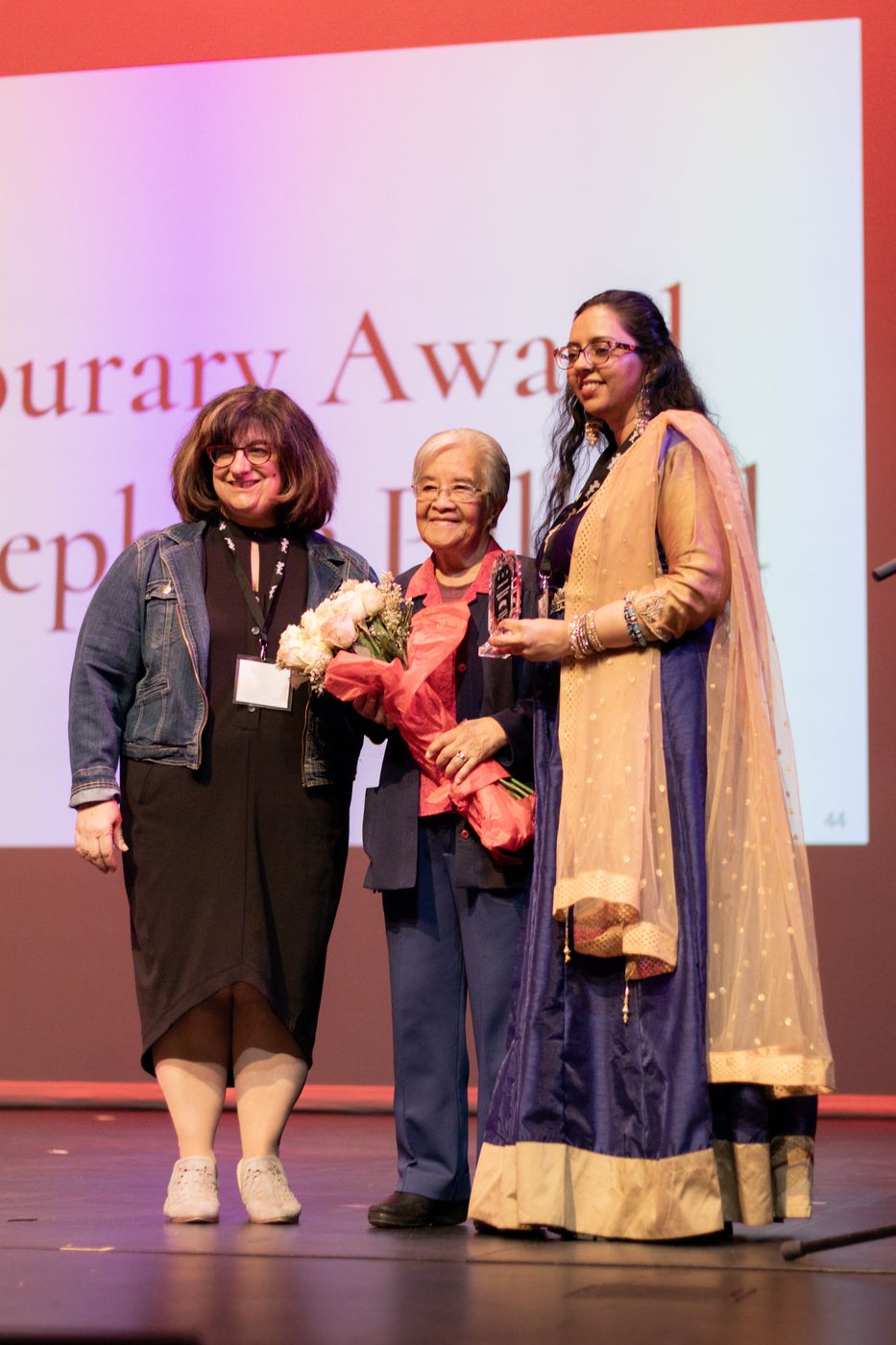 An honorary award being presented on stage.